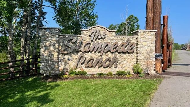 The Stampede Ranch stone entrance sign at the top of the drive